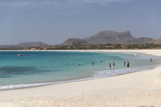banhistas a mergulharem na mar da praia de santa mónica, na ilha da boa vista, em cabo verde